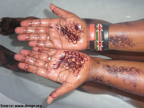 a Kenyan henna tattoo on a woman's hands a Belgian Tattoo on a man's chest